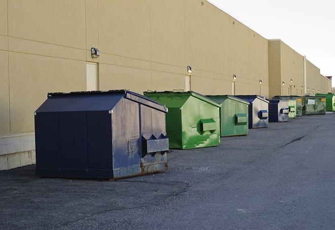 construction waste being loaded into large dumpsters in Alden